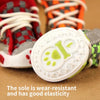 A close-up view of a white shoe sole with a green anti-slip design, showing its wear-resistant and elastic properties.
