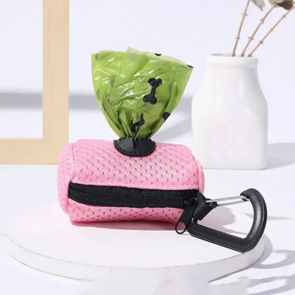 Pink mesh dog waste bag dispenser with a green fabric bag and black strap