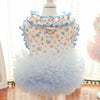 A light blue floral princess pet dress for dogs and cats with ruffled collar and tulle skirt.