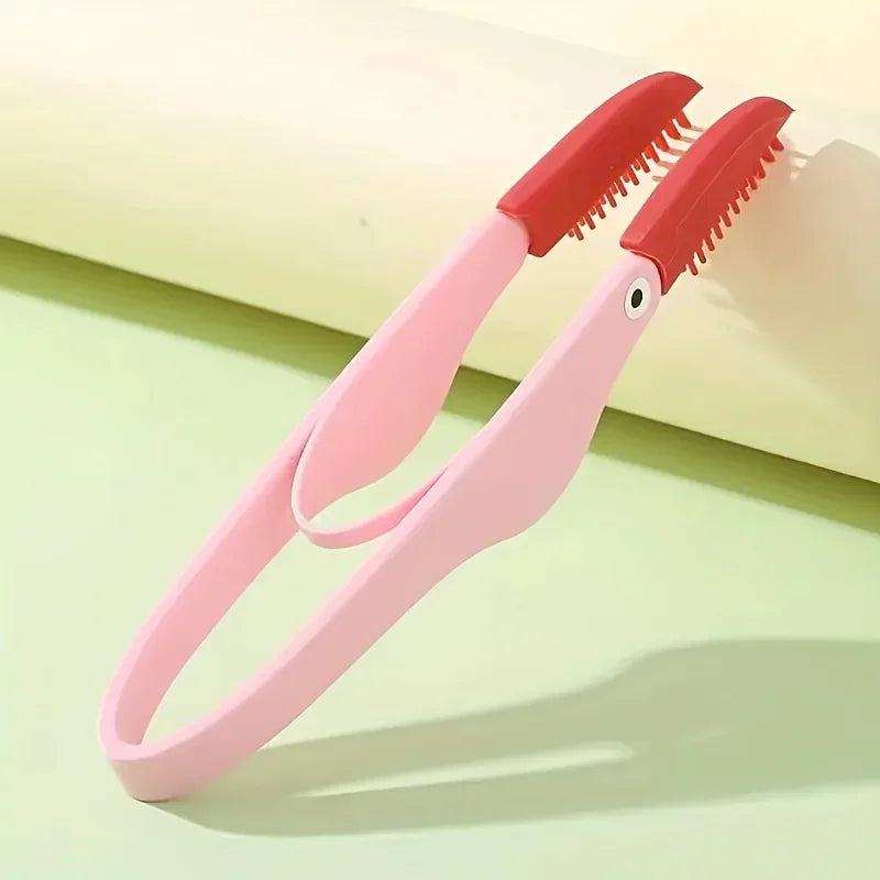 A pink and red comb for pet tear stain removal resting on a light green surface.