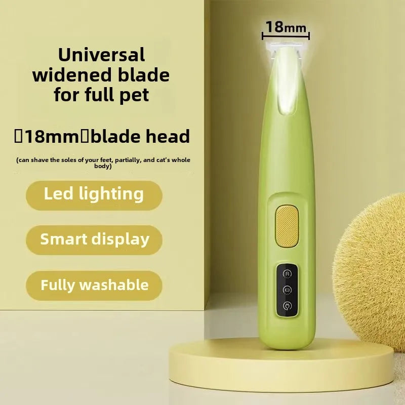 A light green pet hair trimmer with an 18mm blade head and LED lighting displayed on a wooden surface.