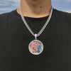 A silver chain necklace with a round pendant featuring a photo of two people.