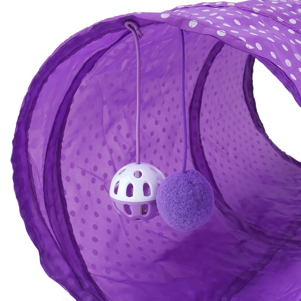 Purple collapsible cat tunnel play tube with a white ball and a purple fuzzy ball