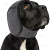A black dog wearing a gray durable ear muff for noise reduction and anxiety relief.