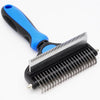 A black grooming brush with a blue handle and metal teeth for deshedding dogs and cats.