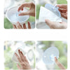 Hands are shown using a suction cup device to clean or apply something on a window surface.