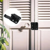 Close-up of a black sliding bolt lock mechanism installed on a white door panel.