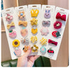A display of five adorable flower-shaped baby hair clips in various colors and textures.