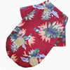 A red short-sleeved shirt with a tropical floral print featuring blue, green, and pink leaves and pineapple motifs.