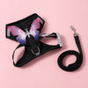 Black harness with a pink butterfly decoration and attached leash for pets