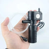 A hand holds a black 3-in-1 aquarium filter pump with tubing and a power cord.