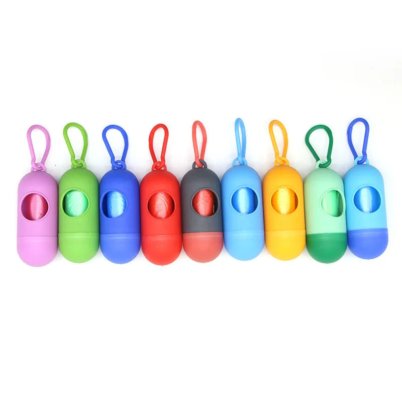 A row of twelve colorful capsule-shaped dog poop bag dispensers with carabiner clips.