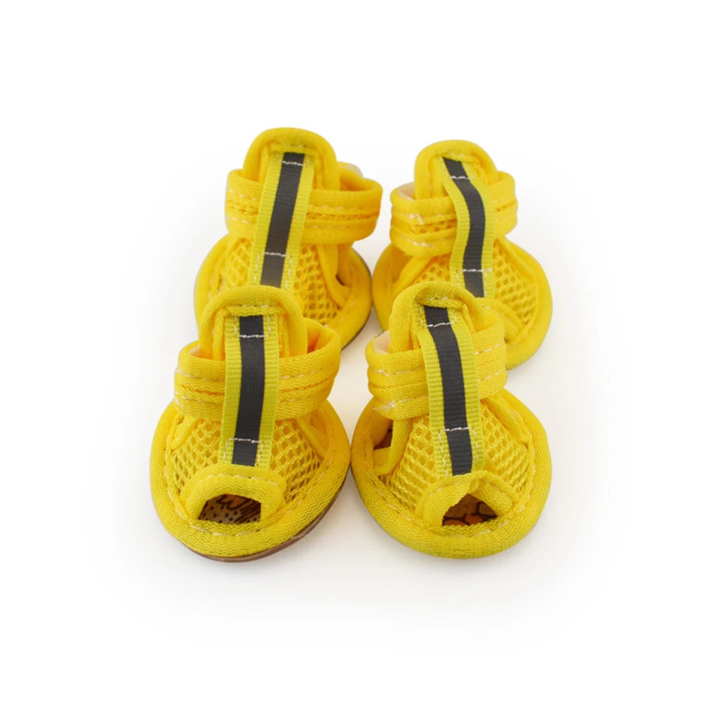 A pair of yellow mesh dog and cat walking shoes with black straps