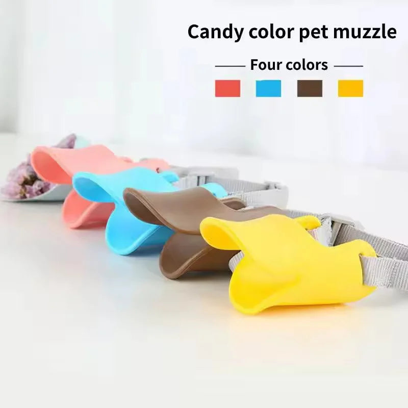 A collection of candy colored silicone dog muzzles in red, blue, brown, and yellow displayed on a white surface.