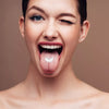 A woman smiling widely showing her tongue and teeth for a realistic sound effect demonstration.