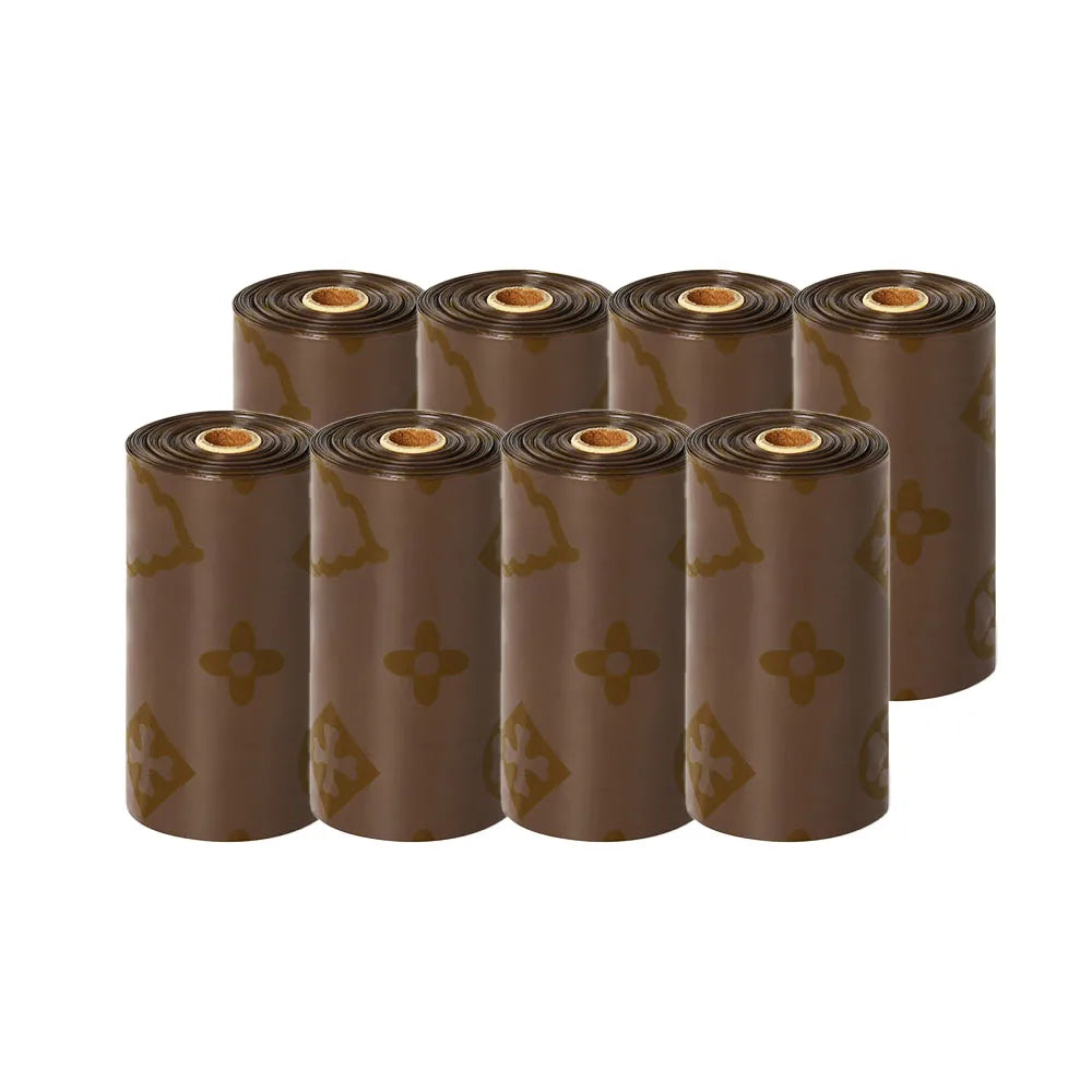 A row of brown biodegradable scented dog poop bags in cardboard tubes.