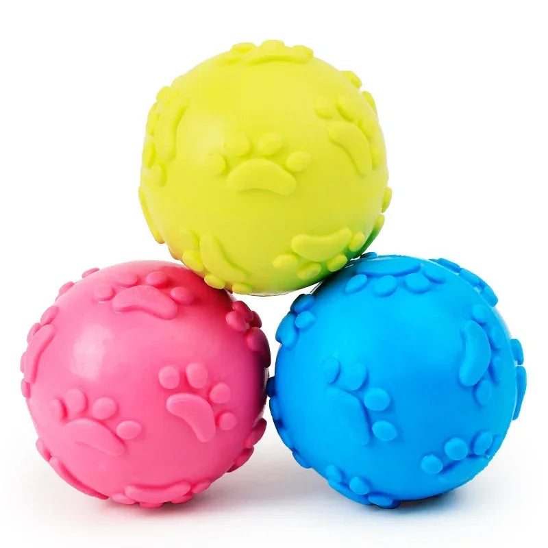 A bright yellow squeaky chew toy shaped like a paw print for dogs.