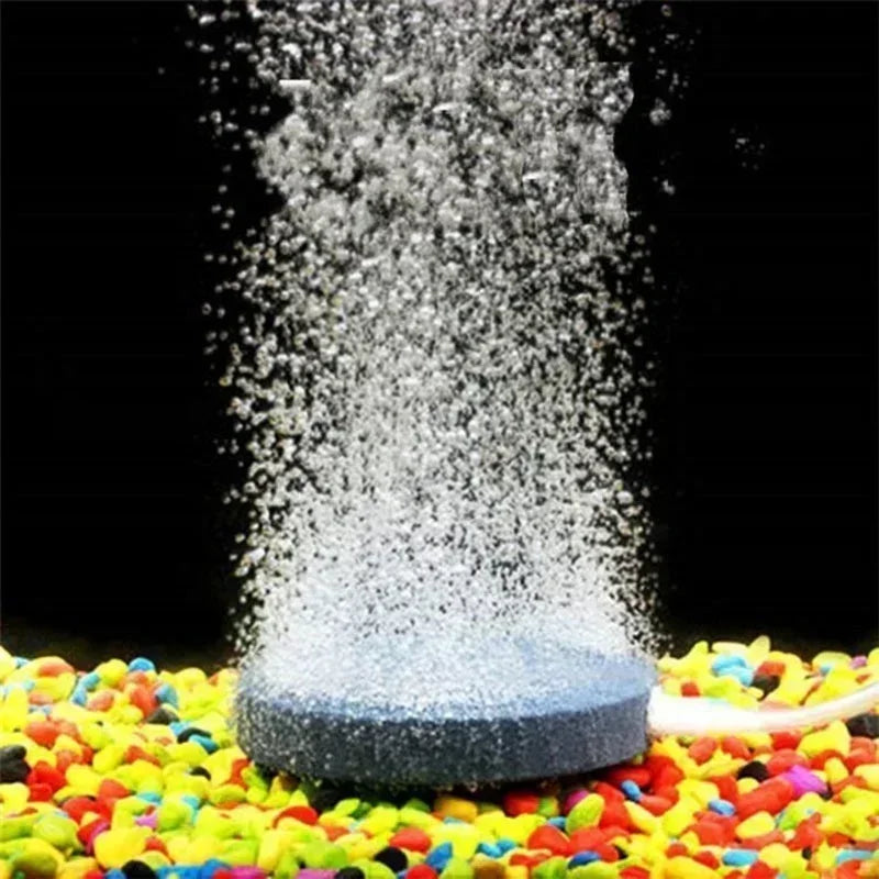 A 40mm air stone disc is shown dropping fine white particles onto a colorful surface.