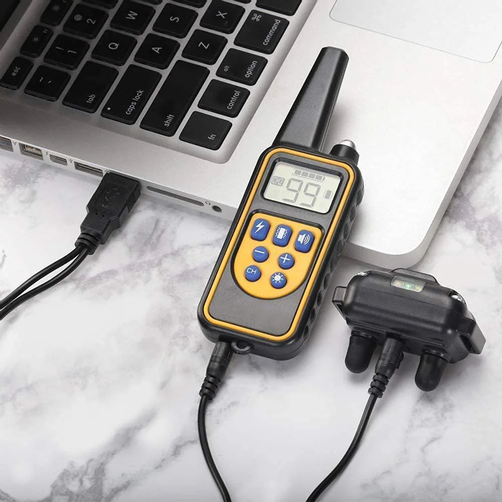 A handheld electric dog training collar with a digital display showing 99, connected by a black cable.