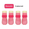 A 4-piece set of rose pink waterproof anti-slip dog boots for small breeds.