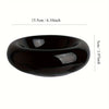 A black ceramic donut cat bowl with a smooth, rounded shape and non-slip base.