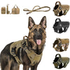 A German Shepherd wearing a heavy duty tactical dog harness with a molli pouch system and padded vest.