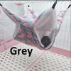 A grey cozy double-layer fleece hammock for small pets is shown inside a white cage.
