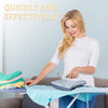 A blonde woman is using a manual lint remover brush on a piece of fabric.