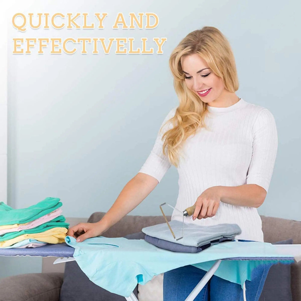A blonde woman is using a manual lint remover brush on a piece of fabric.