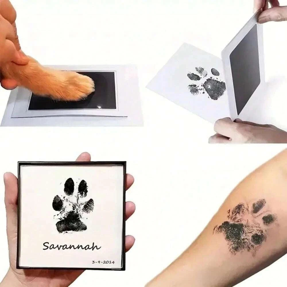 A hand holds an inkless pet paw print kit showing a black paw print and the name Savannah on a white background.