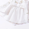 White summer dress for a dog featuring a bow and butterfly-patterned skirt
