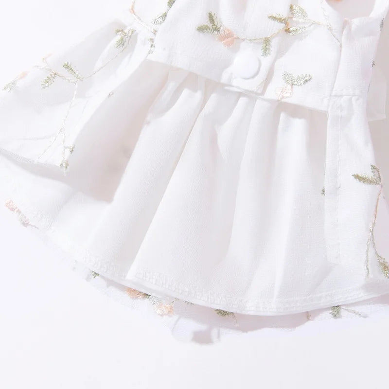 White summer dress for a dog featuring a bow and butterfly-patterned skirt