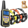 A black remote dog training collar with a yellow display and buttons, next to a golden-colored dog.