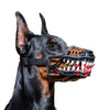 A black dog wearing a funny muzzle costume with fake blood dripping from its teeth.