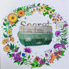 A bird cage seed catcher skirt made of nylon mesh with a green fabric base and decorative floral greenery.