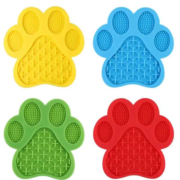 A set of silicone pet licking mats in yellow, blue, green, and red with suction cups for dogs and cats