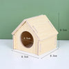 A natural wooden hamster house with an angled roof, shown from above.