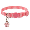 A pink and white striped collar with a pink bow pendant for a cat.