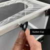 A hand is applying a suction cup to the mesh lid of an aquarium fish breeding isolation box.