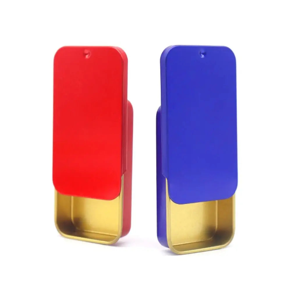 A compact sliding lid tin box in red and blue for storing treats, pills, and small items.