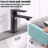 A black faucet is shown dispensing clean water into a mesh cleaning tool for a fish tank.