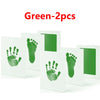 Green baby handprint and footprint kits with white cards for keepsakes