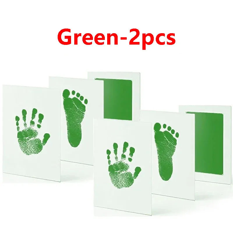 Green baby handprint and footprint kits with white cards for keepsakes