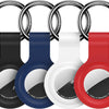 A set of silicone airtag protective covers in black, blue, white, and red attached to metal keychains.