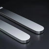 A pair of sleek, silver stainless steel aquarium plant tweezers lying on a dark surface.