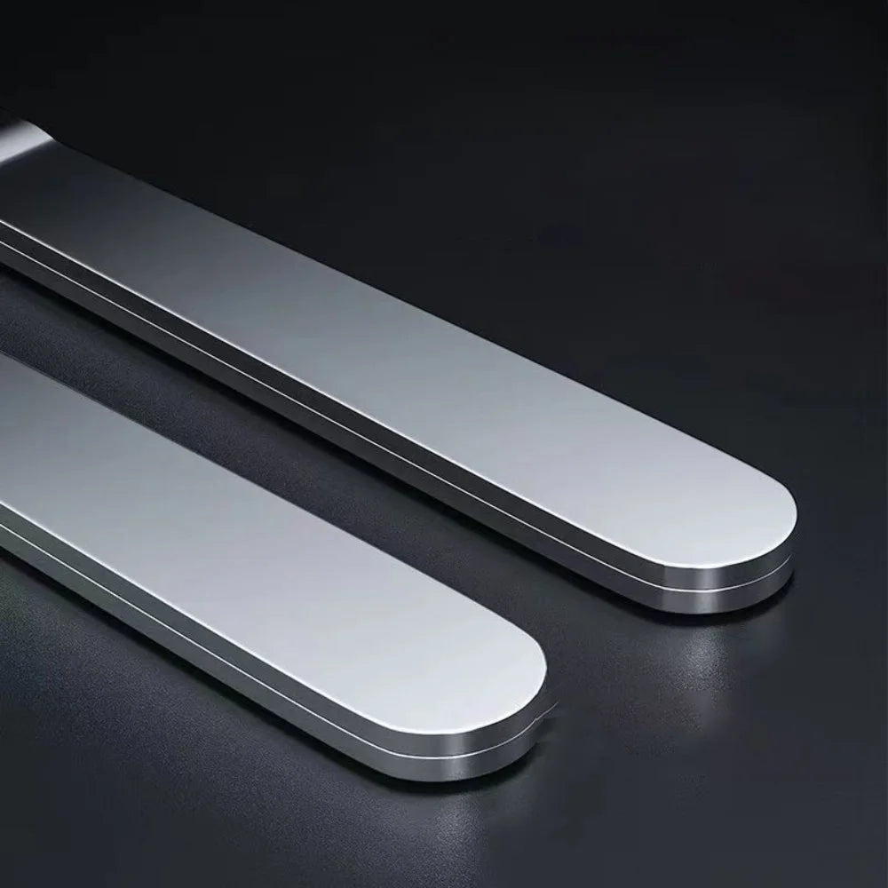 A pair of sleek, silver stainless steel aquarium plant tweezers lying on a dark surface.