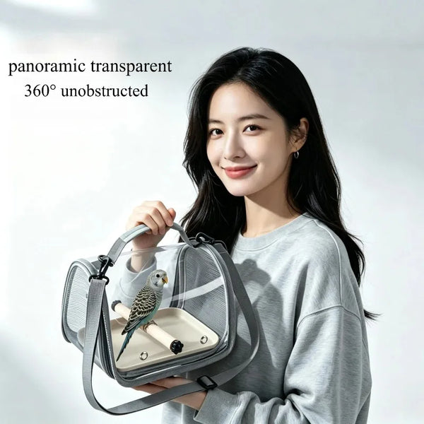 A woman holds a transparent pet travel bag with a stand for a bird against a bright background.