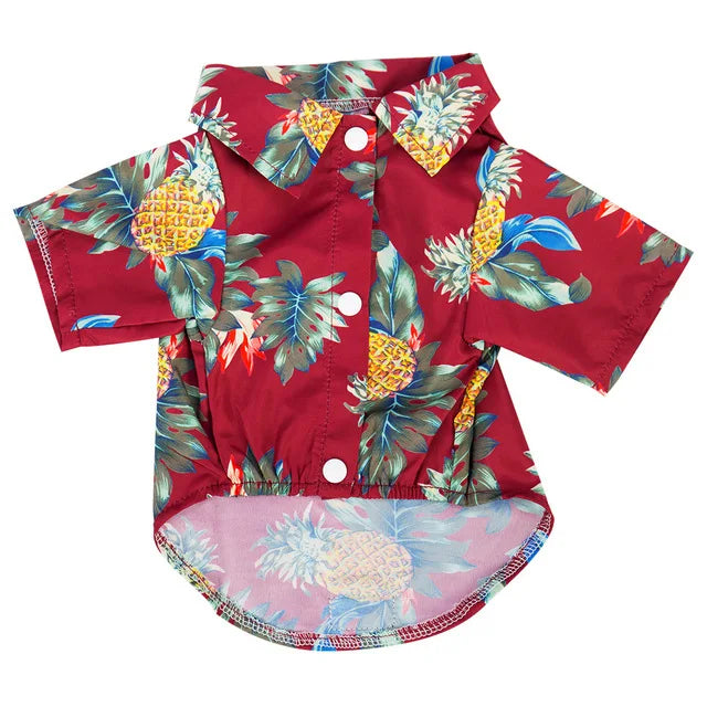 A red shirt with a tropical pineapple and leaf print, featuring a collared design.