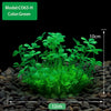A clump of green artificial aquarium plants growing in dark gravel.