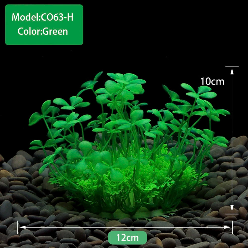 A clump of green artificial aquarium plants growing in dark gravel.